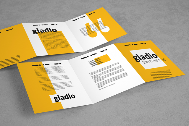 Deux vues d'un dépliant plié bifold jaune et blanc pour la marque 'Gladio – The New One', montrant la couverture et l'intérieur côte à côte sur surface grise. Sprint24 imprime des dépliants pliés personnalisés en 4 types de plis et 5 formats standard sur papier couché 115 gr — idéaux pour lancements produits et campagnes publicitaires.
